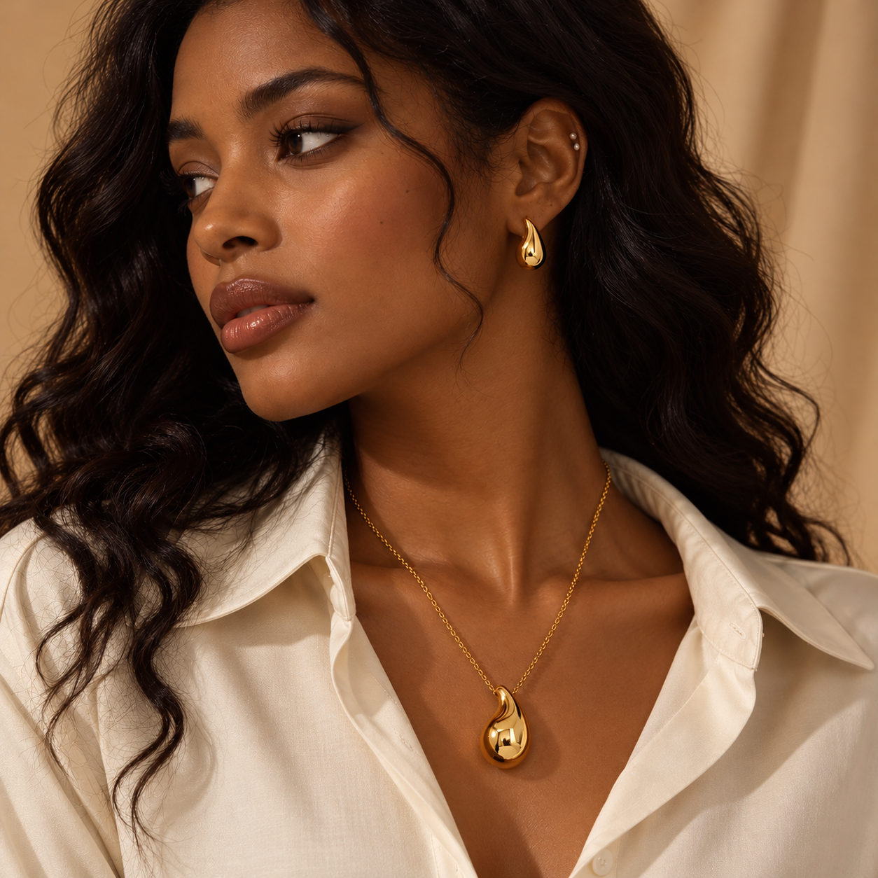 Model wearing a gold pendant necklace