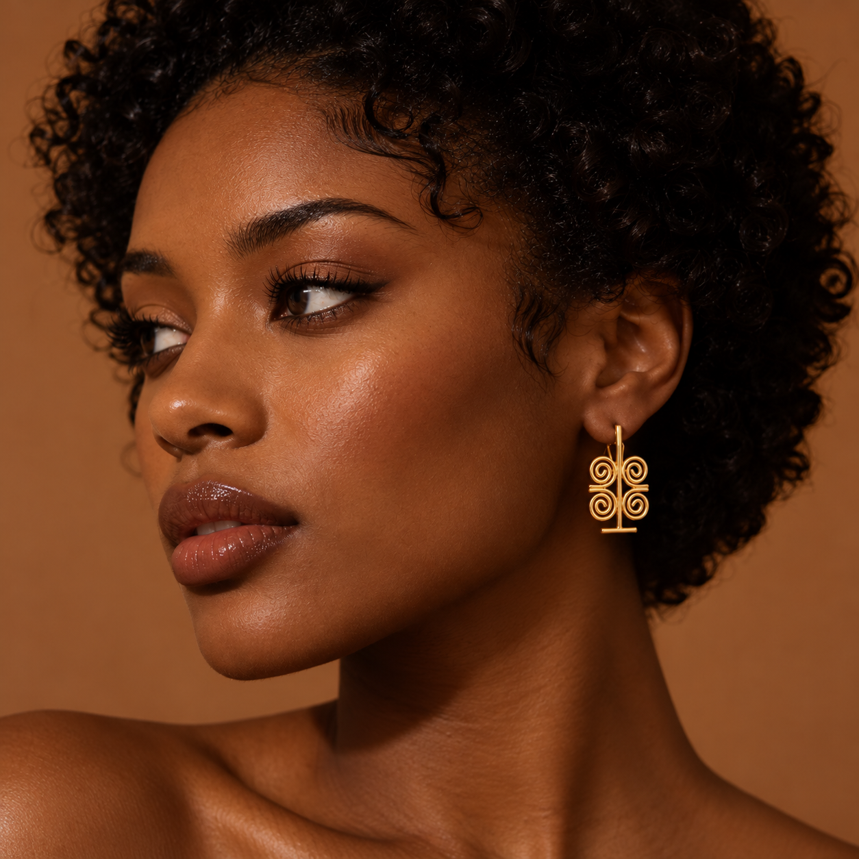 Gold earring inspired by symbolic form