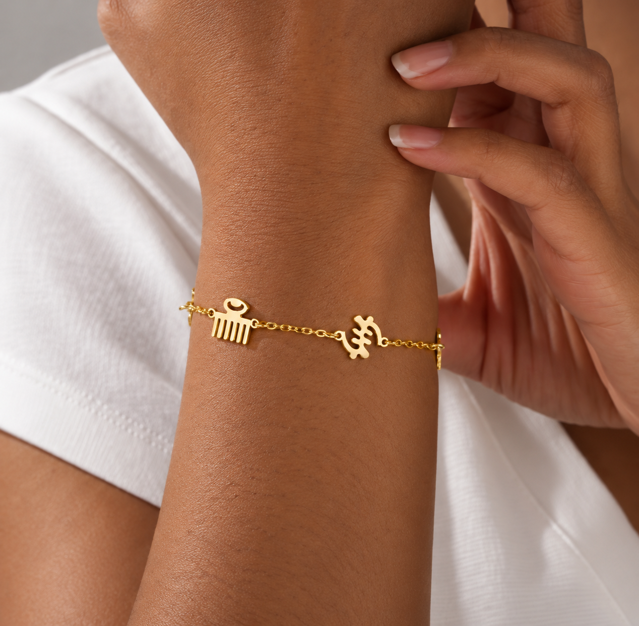 Gold symbol bracelet worn on the wrist